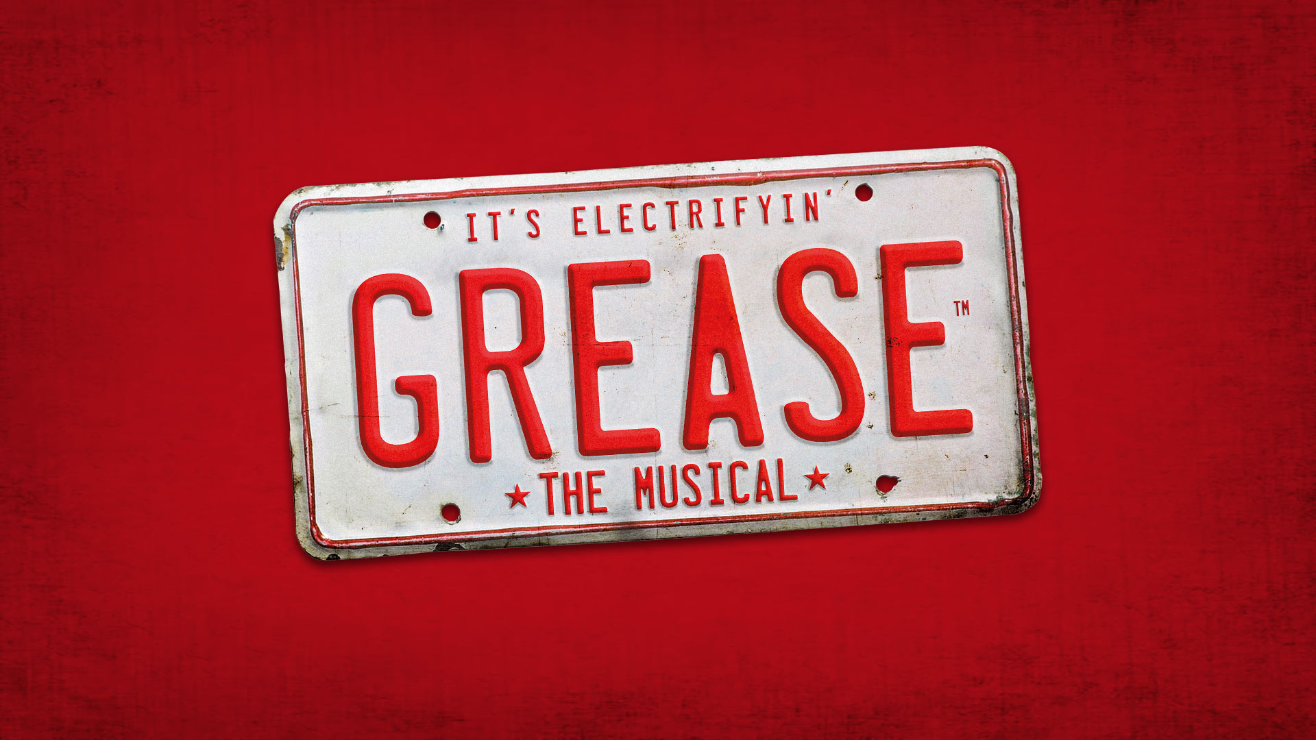 The word Grease in red on an old 50s-style number plate