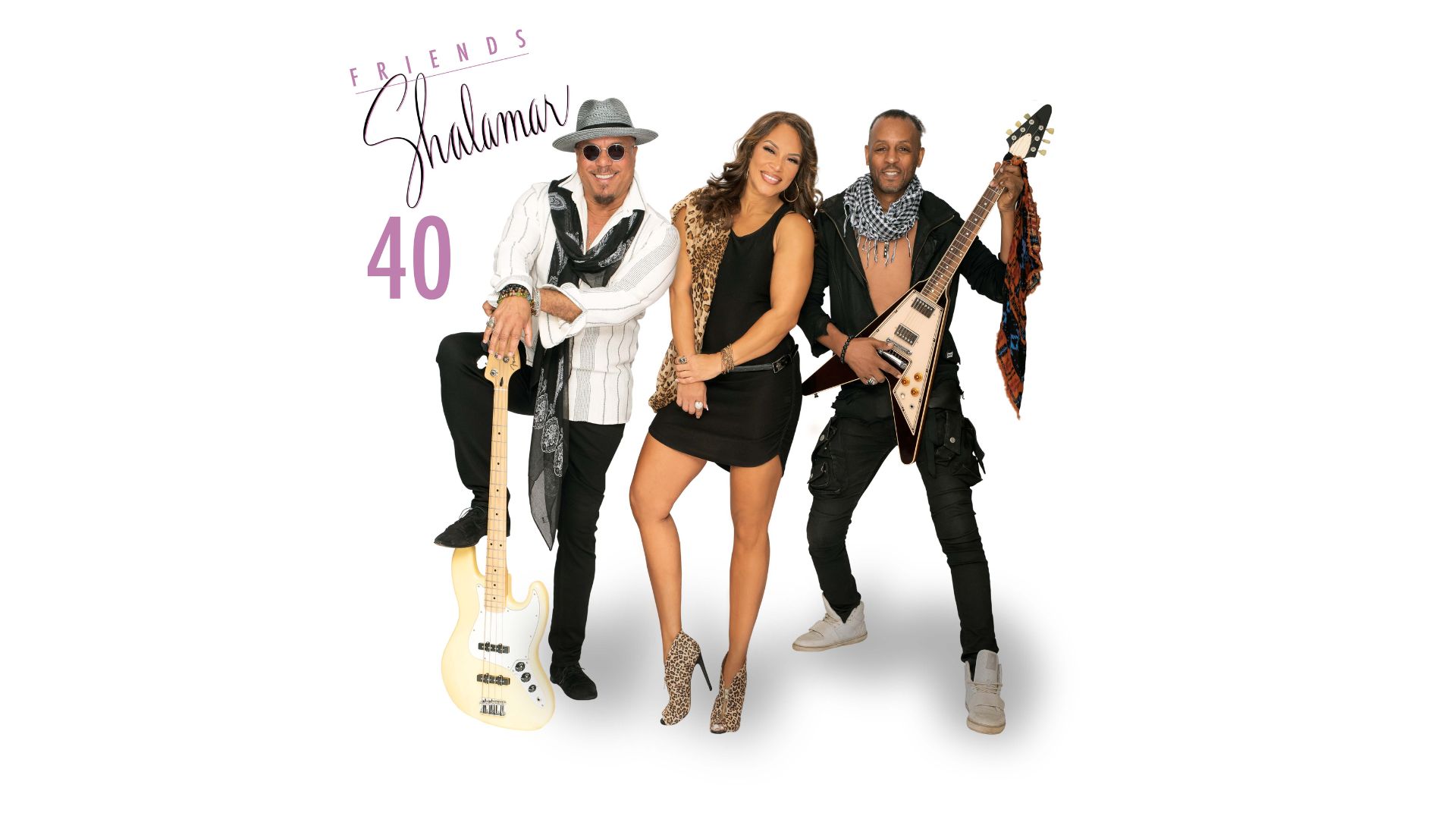 A lady in a short black dress stands between two men one with guitar the other with a bass